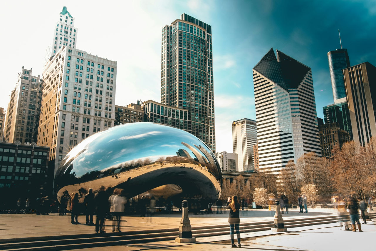 Downtown Chicago scene with buildings and silver Cloud Gate sculpture