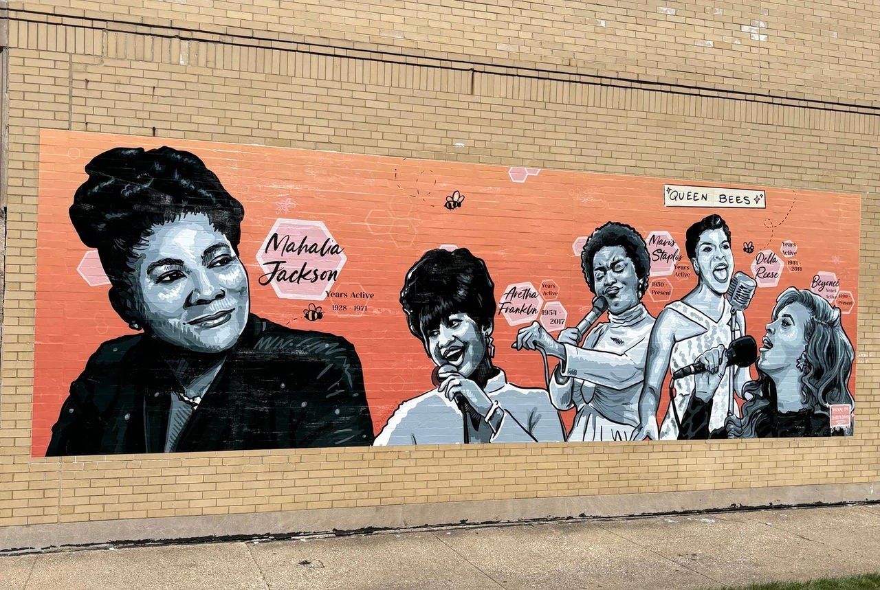 Mural on a brick wall with black-and-white depictions of Mahalia Jackson, Aretha Franklin, Mavis Staples, Della Reese and Beyonce