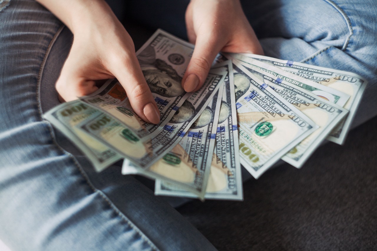 Hands holding a money fan.