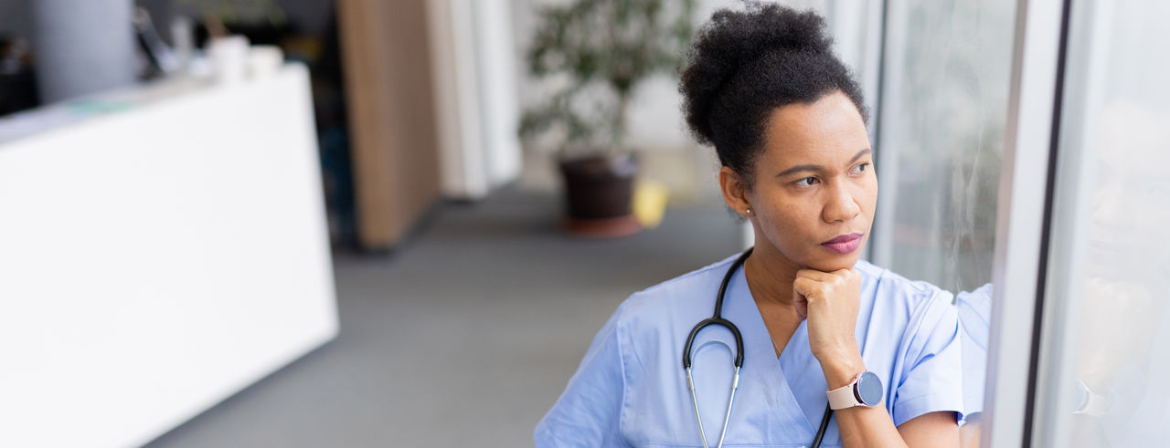 Nurse looking outside a window