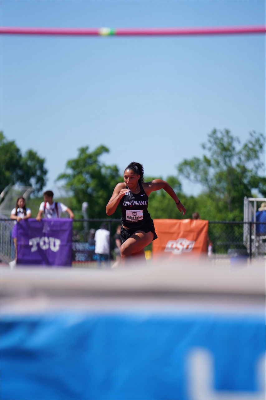 UC senior high jumper Mallory Mullen competing in an outdoor track and field meet.