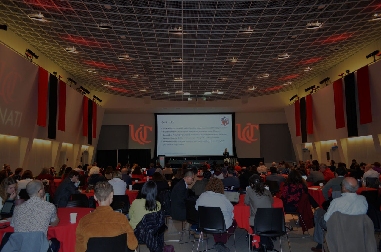 Dallas Maddox, Strategy Lead, US Higher Education Analytics, AWS, delivers his keynote presentation, “From Cloud to Cognition – How AI Is Reshaping the Future of Higher Education and Athletics,” to 2026 DTS AI & Emerging Technology Symposium attendees.