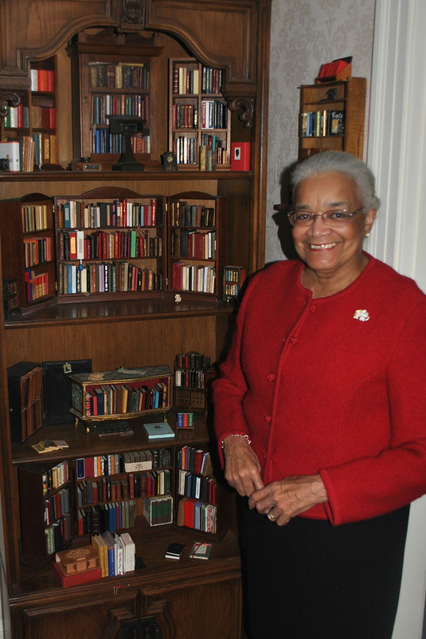 Melinda C. Wells Brown beside her collection. 