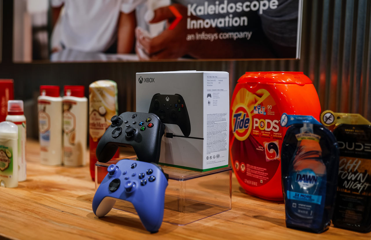 X-Box controllers, Tide Pods and other products on a display table.