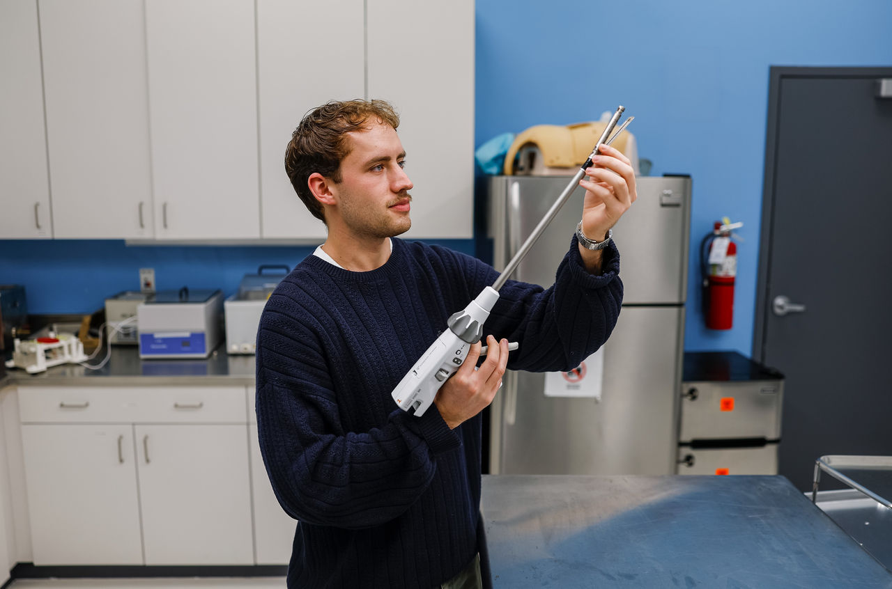 Titus Koesters demonstrates a medical device in a mock treatment room.