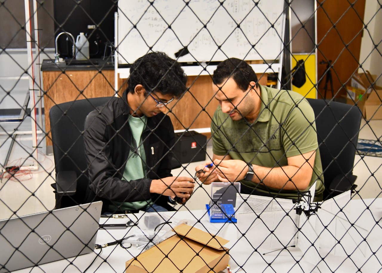 Ahmed Elgohary and his collaborator work on a moth-like drone. 