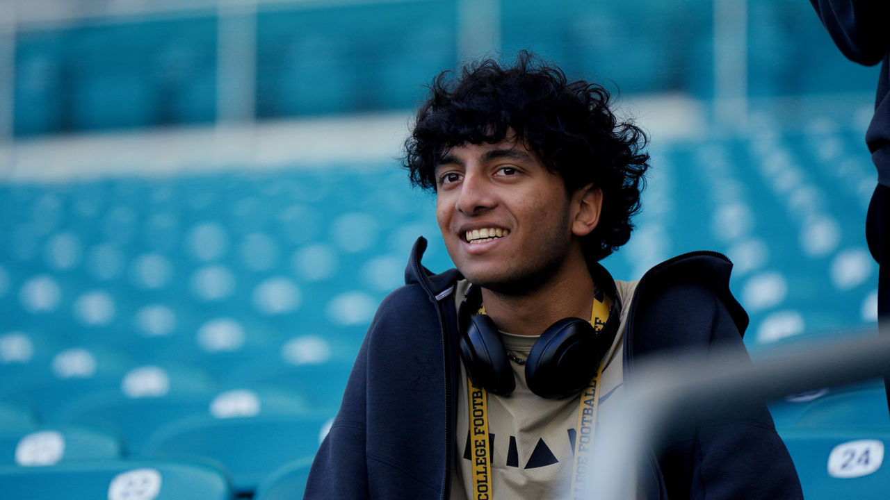 Jayden Balwally sits in the empty stands of Hard Rock Stadium, where he worked as part of the University of Cincinnati co-op program