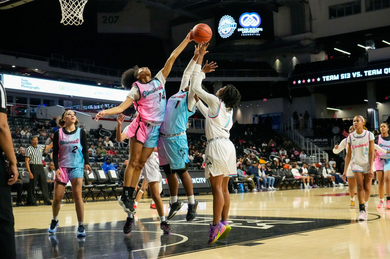 Three young women jump for a basketball in a CPS All-Star Showcase game.