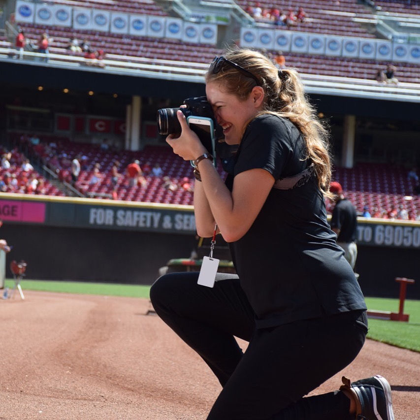 Emily Witt, a Bearcat for Life, taking a photograph in Cincinnati's Great American Ballpark