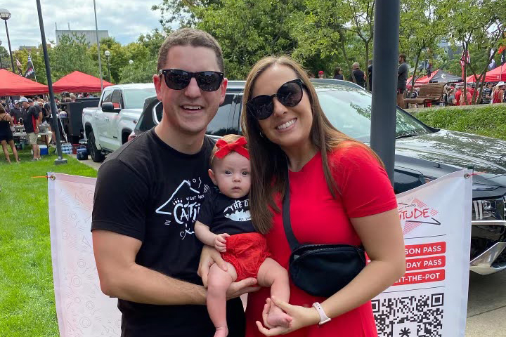 Brandon Trame, a Bearcat for Life, with his wife and baby