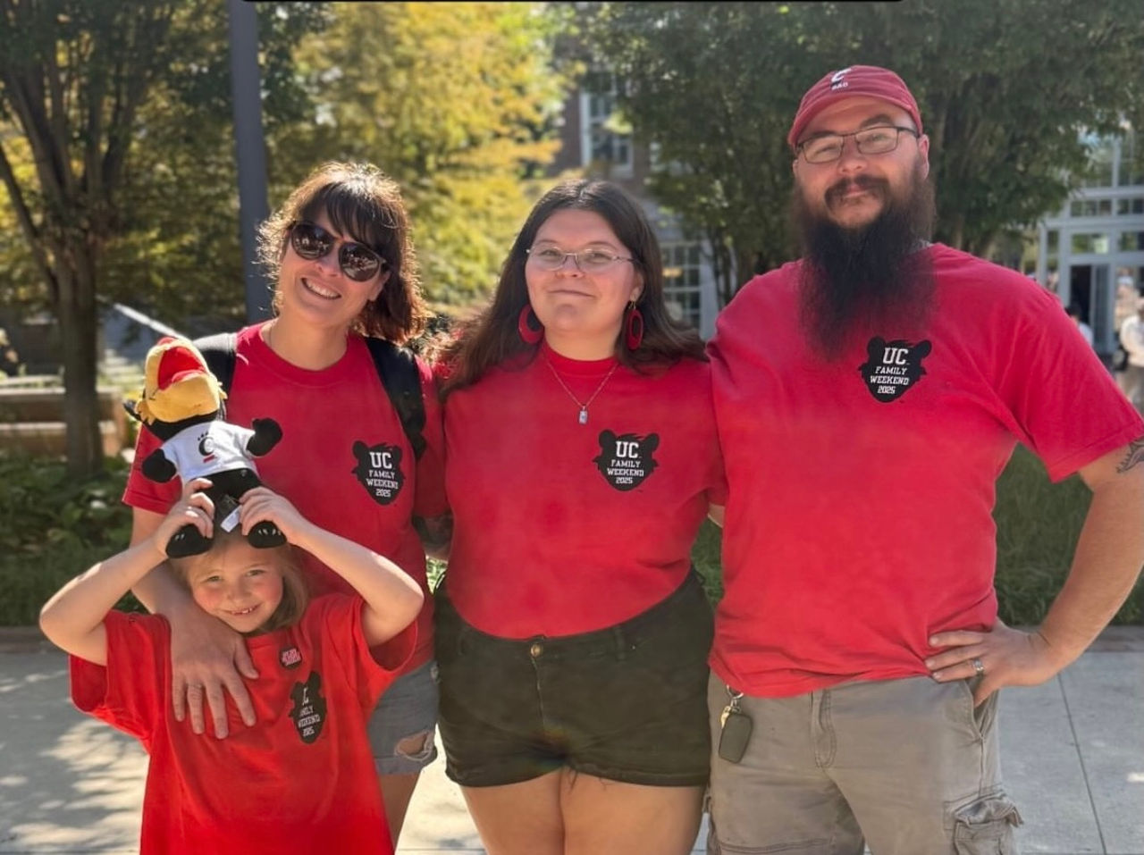 Katy Cardoza and her children in red UC T-shirts, all Bearcats for life