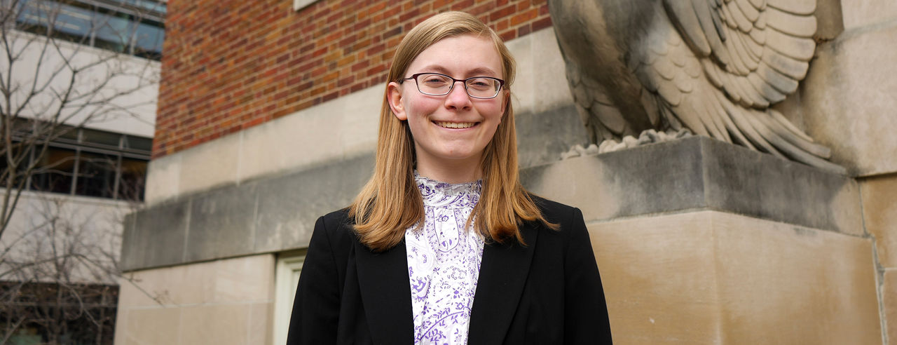 Sage Bushstone stands outside smiling