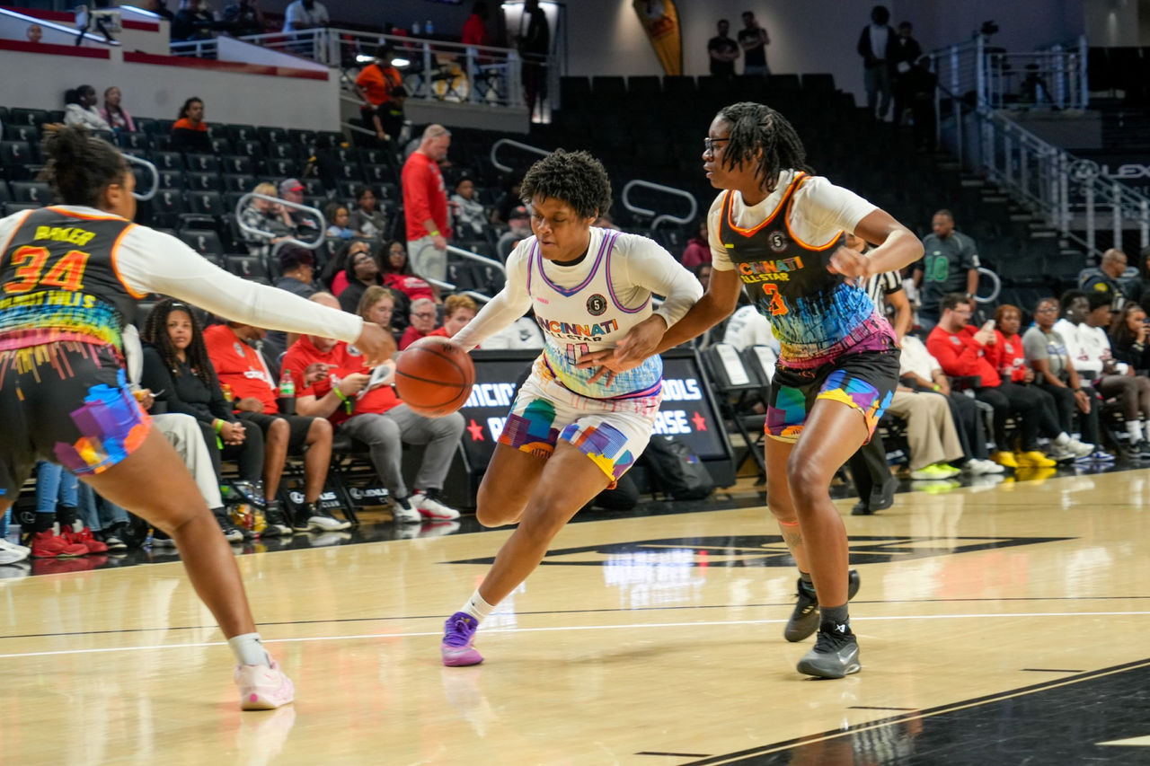 Three high school athletes from Cincinnati Public Schools race the court of Fifth Third Arena during the Girls All-Star Game.