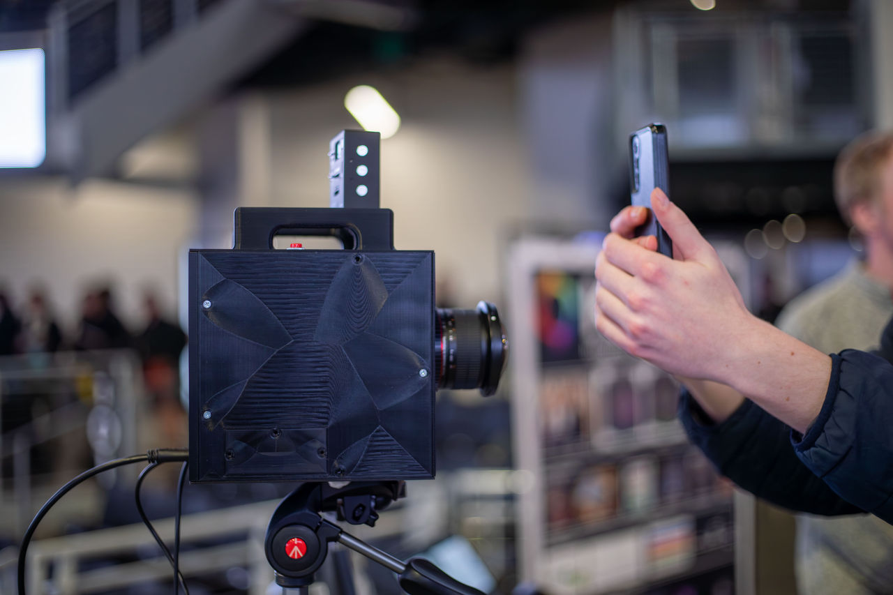 Person taking a photo of the Kromico camera