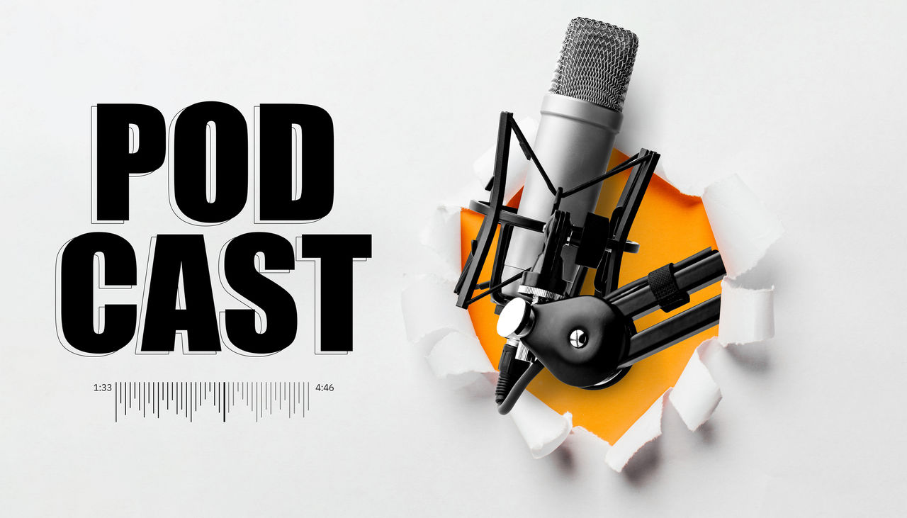 Microphone shown with the word podcast in the background