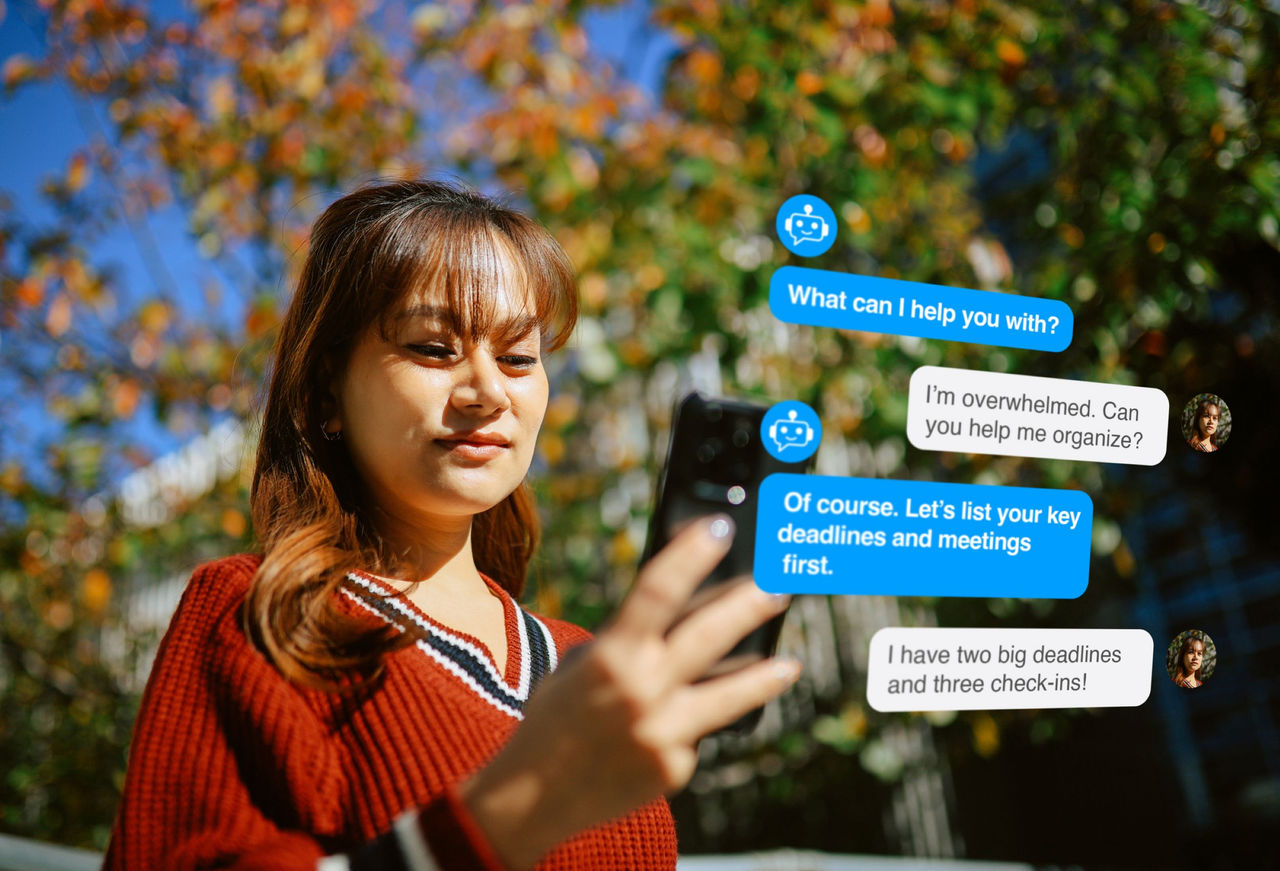 Young wam stands looking at a cell phone and we see messages in bubbles from a chatbot