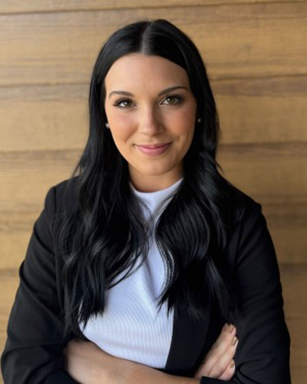 Sam Surber stands with arms folded