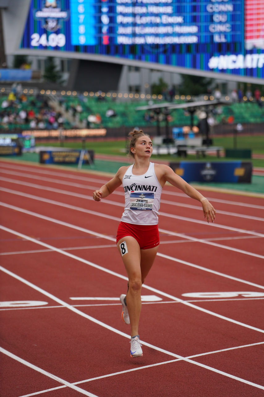 Juliette Laracuente-Huebner runs on an outdoor track during a meet
