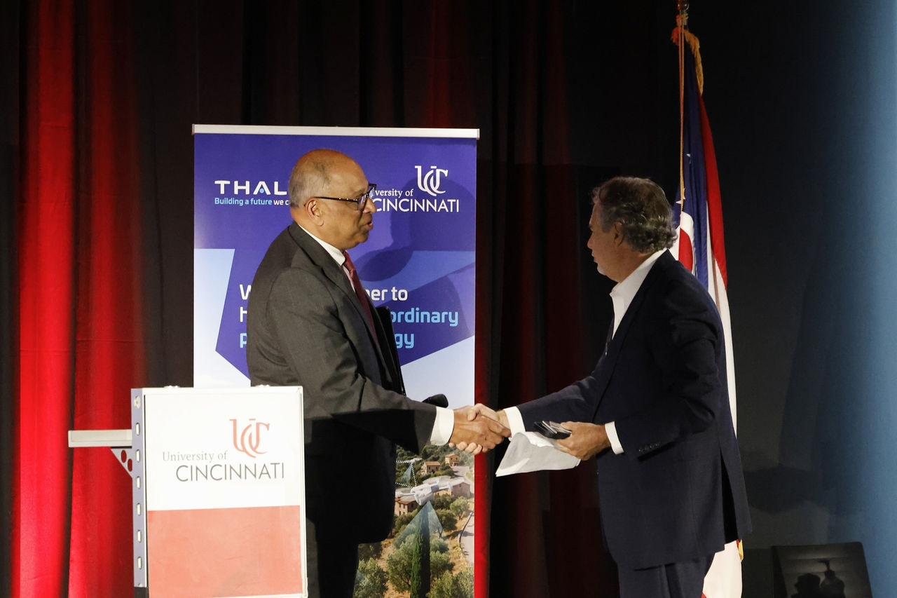 President Pinto shakes hands with Thales' Alan Pellegrini.