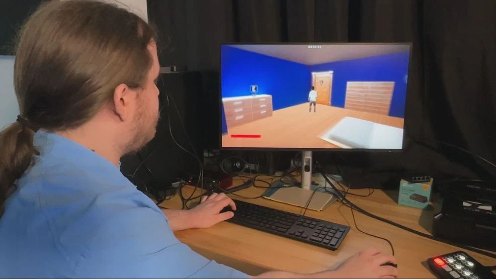 UC Student Tyler McCall demonstrating video game Fire Escape