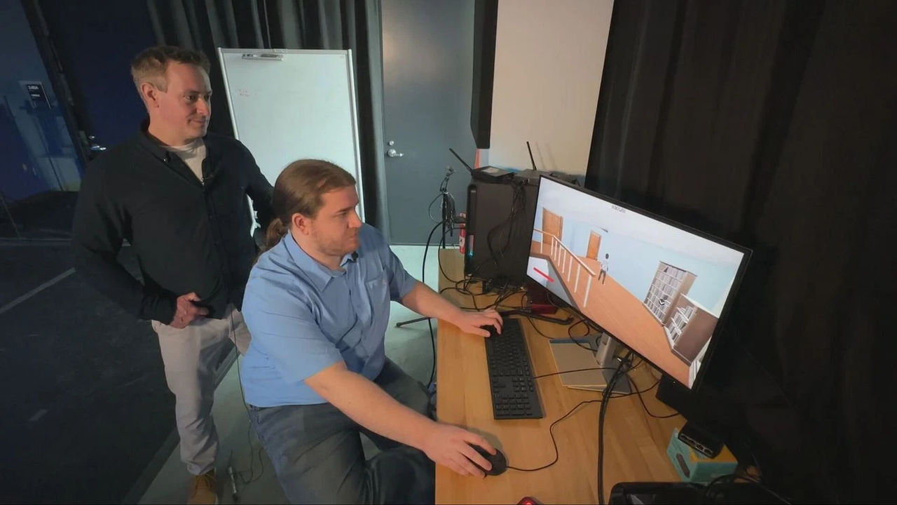 D'Arcy Smith and Tyler McCall at a computer screen demonstrating Fire Escape