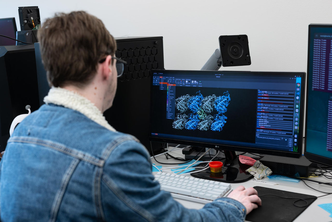 Carter St. Clair works at a computer screen that shows the function of brain cells.