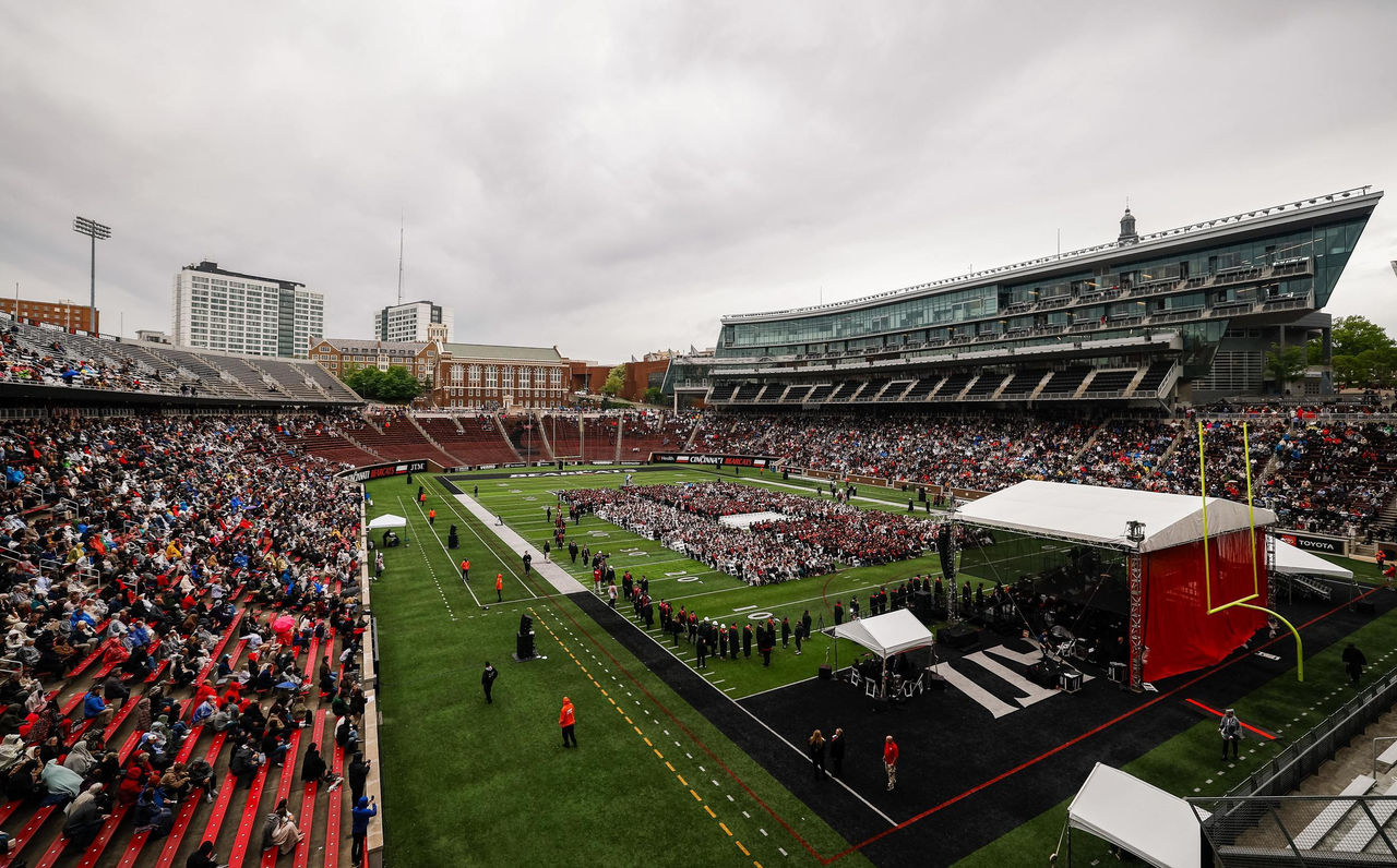 Graduates and their families and friends gather at Nippert Stadium during spring commencement.