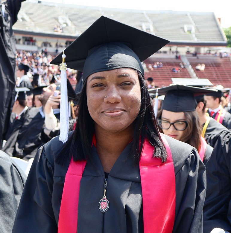 Portrait of Markeisha Davis in her cap and gown at Nippert Stadium.