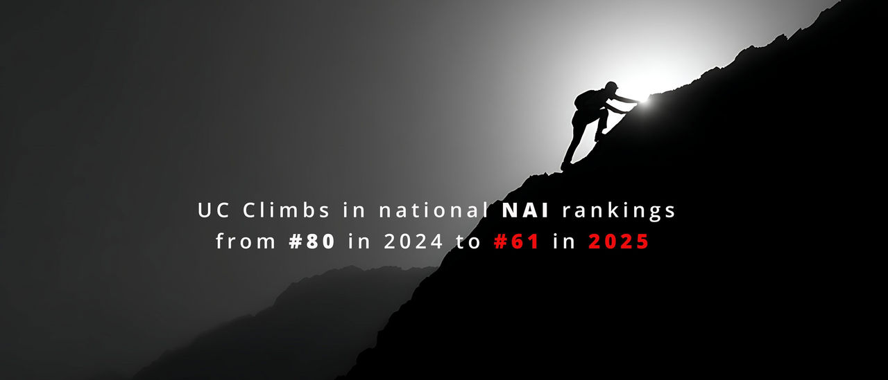 A lone climber in silhouette climbs a steep hill backlighted by the sun in black and white with the text UC climbs in national NAI rankings from #80 in 2024 to #61 in 2025. 