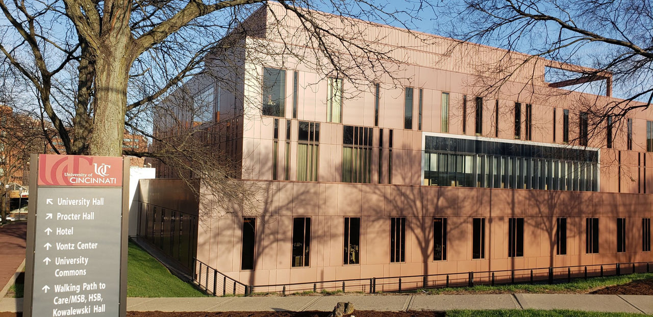 Procter Hall side view with a sign showing buildings on the university campus