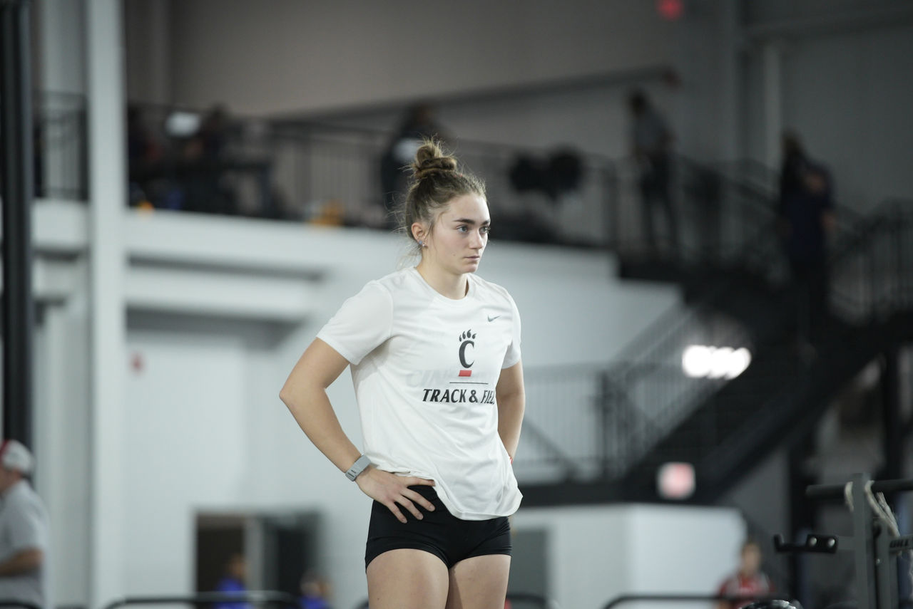 Juliette Laracuente-Huebner stands with hands on hips at track meet