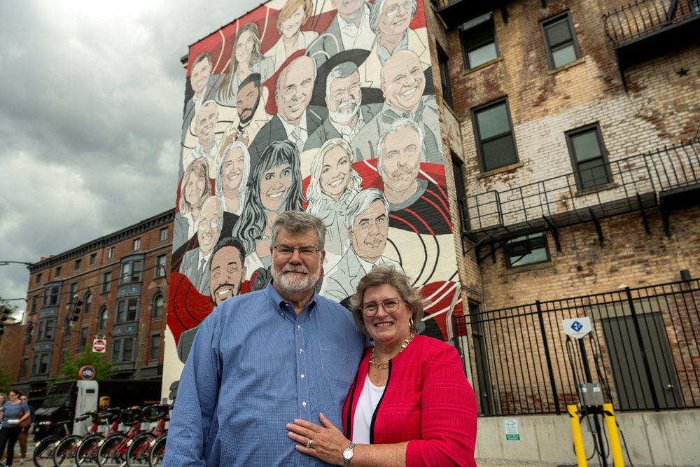 Mark and wife Elizabeth standing in front of the Alumni Celebration Mural in Over the Rhine, Cincinnati OH