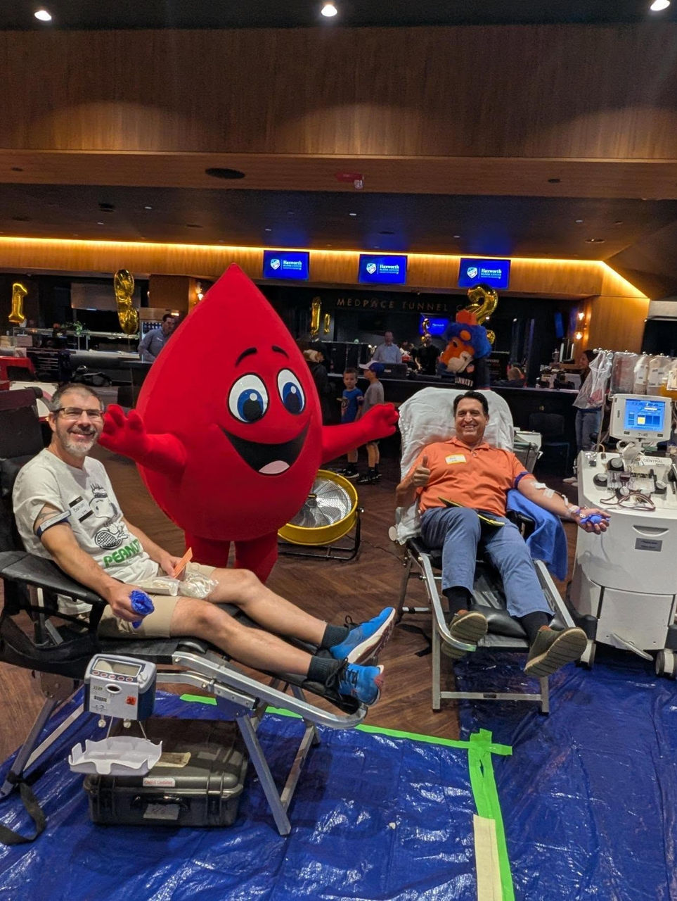 Buddy the blood drop with blood donors at TQL Stadium