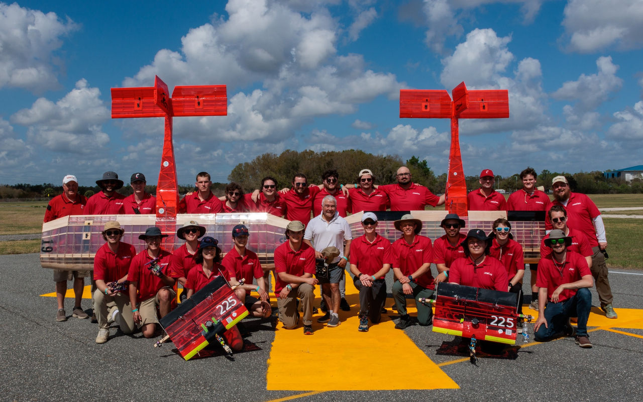 Aerocats regular and advanced teams pose with their planes 