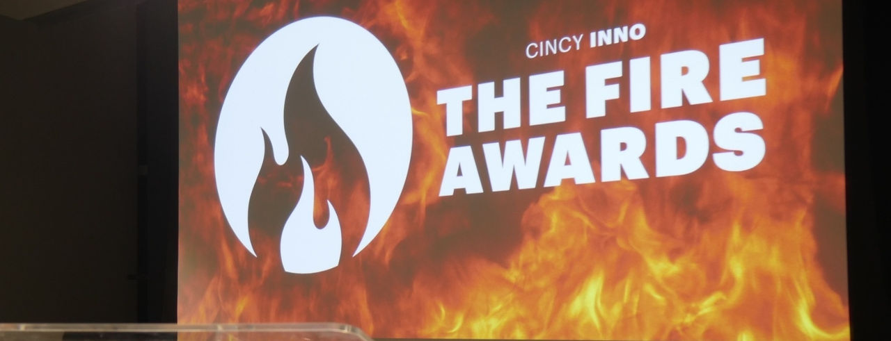 A projector image on a screen reads The Fire Awards with a flame logo.