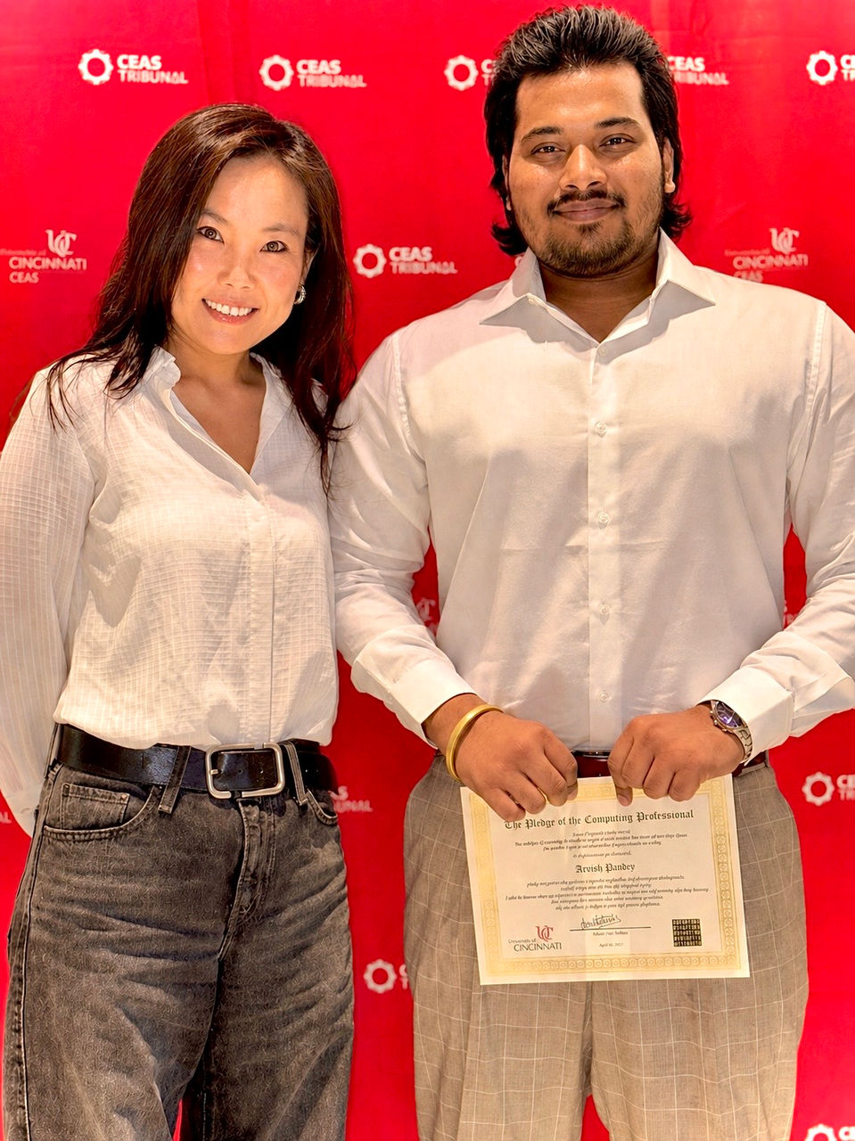 Dr. Jun Bai and Arvish Pandey are shown with Pandey holding a certificate.