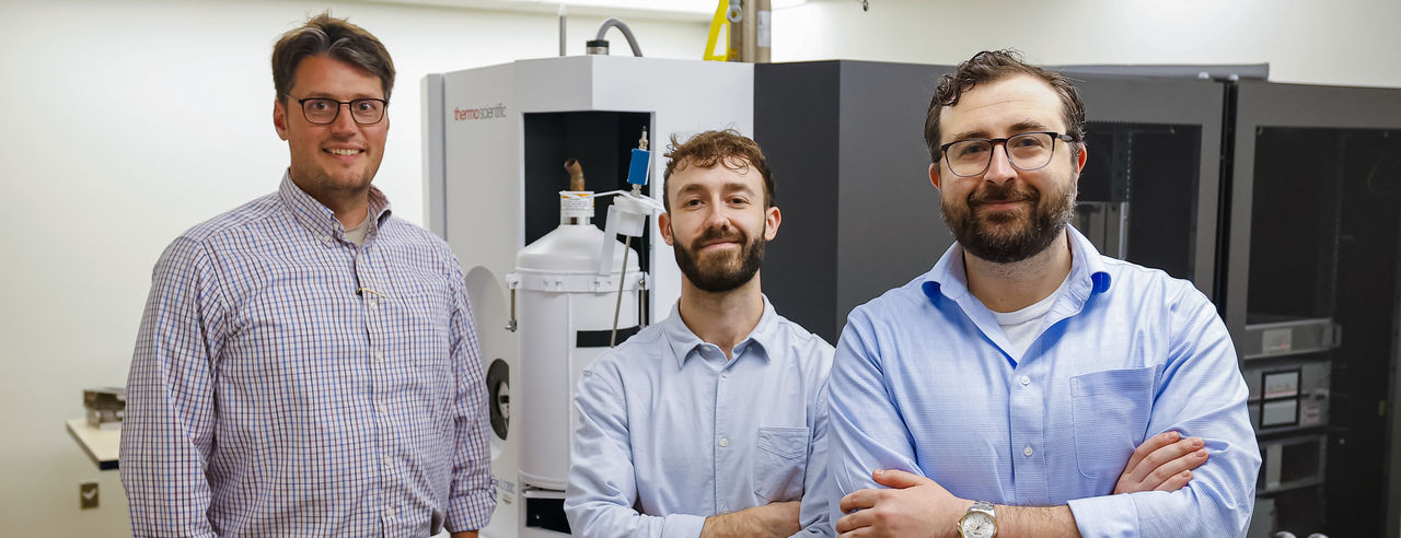 Tom Seegar, PhD, Joe Ungvary, graduate student and  Joe Maciag, PhD, in front of a machine.