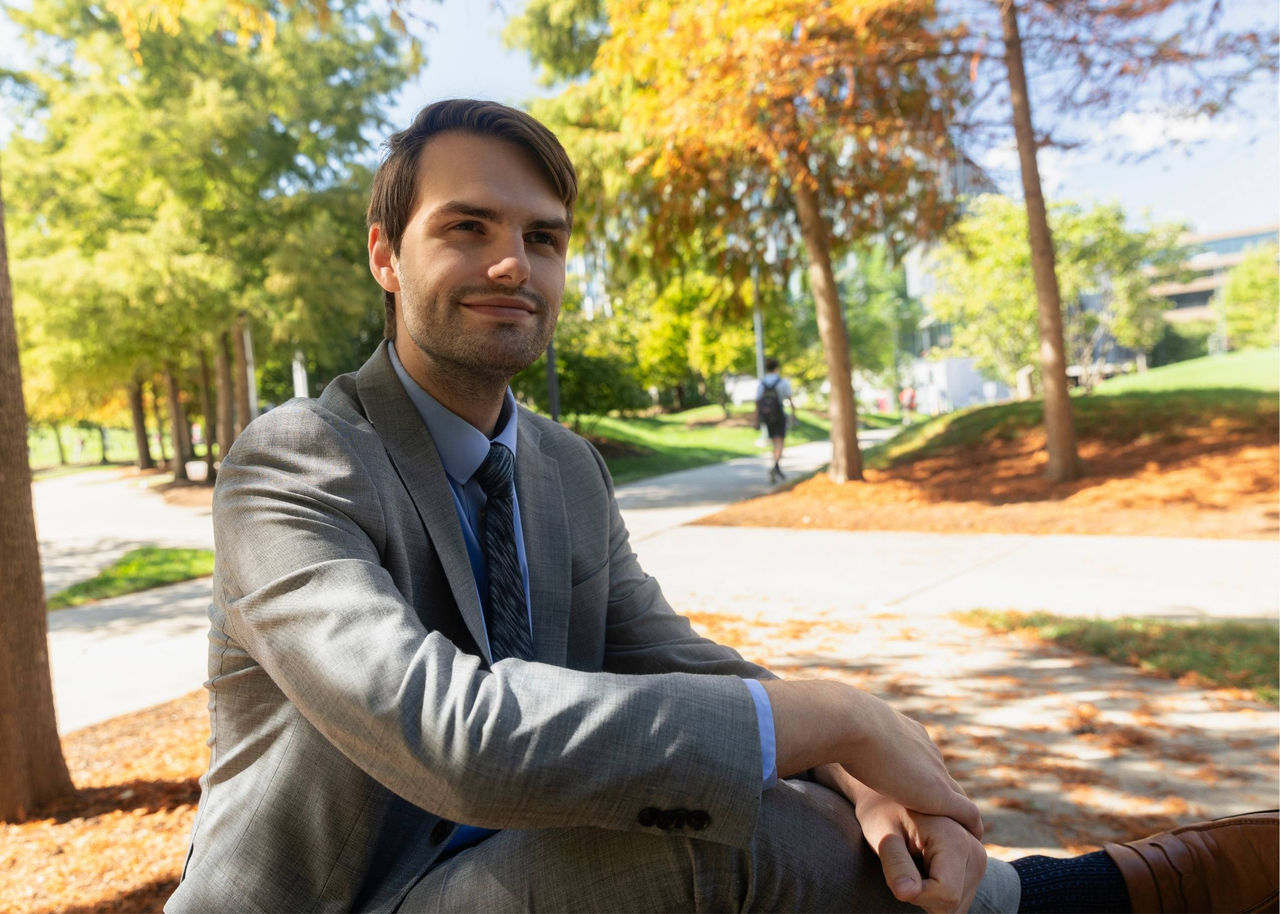 Robbie Webb, recent UC Law graduate, relaxes outside law building