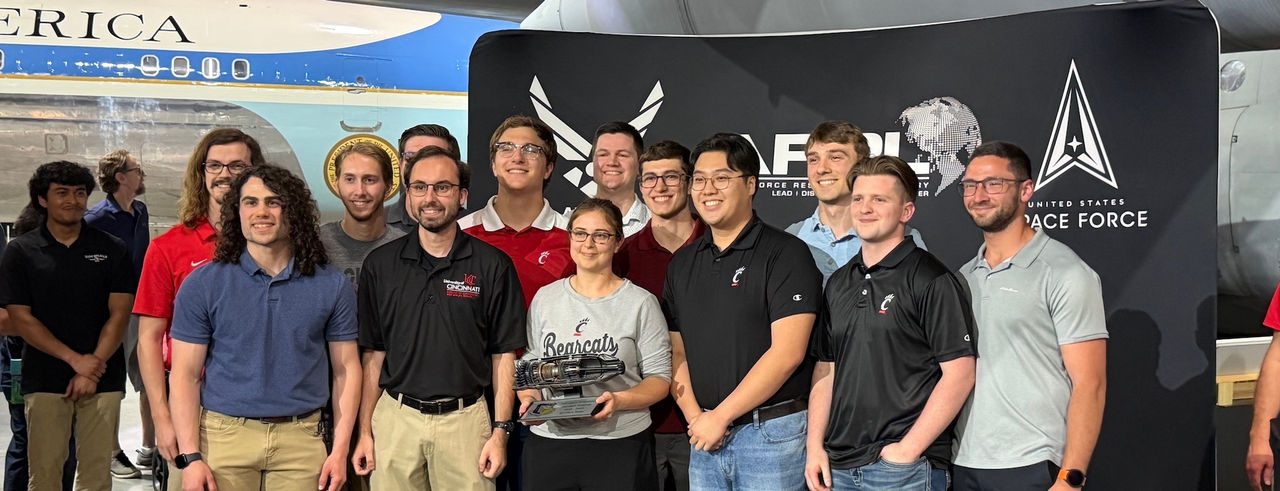 APOP student team poses with their engine at the AFRL