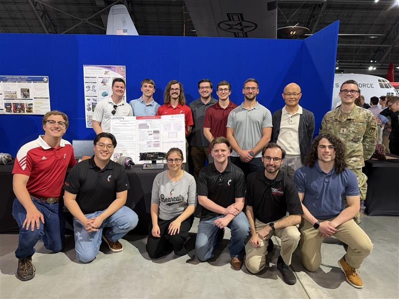 APOP student team poses with their poster at the AFRL facility