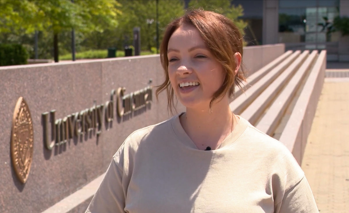 A screenshot of Allison Rickfelder in front of the UC Fountain.