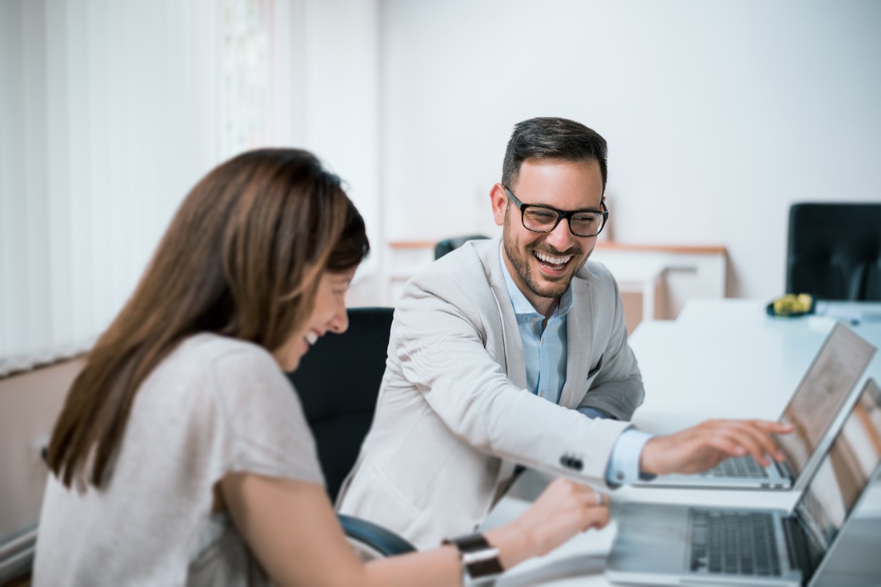 Colleagues talking in an office.