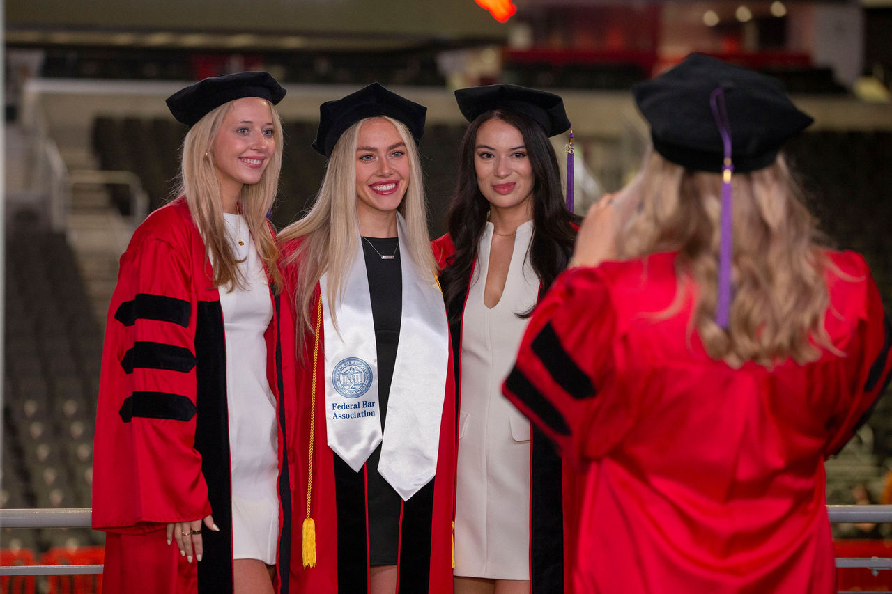 UC Klekamp Law students from the Class of 2026  take photos at Hooding ceremony