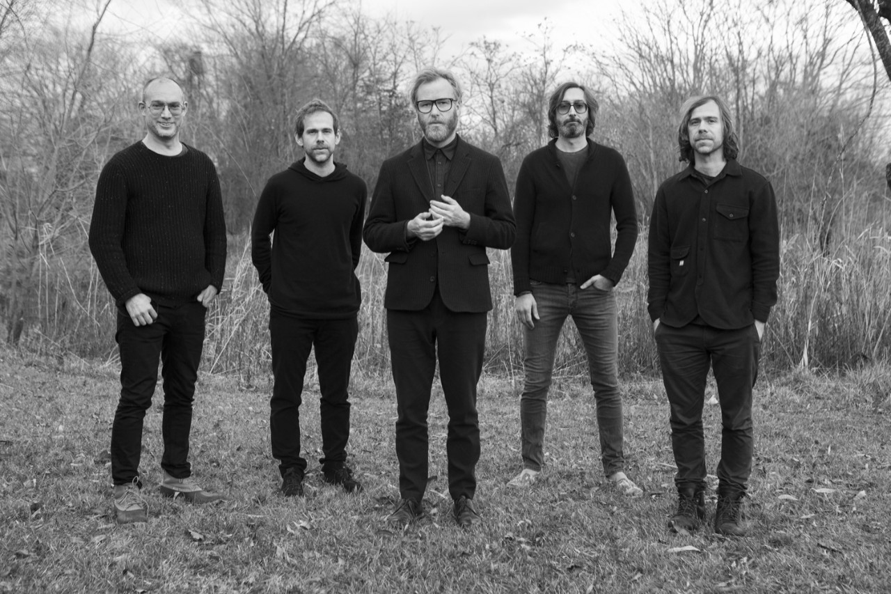 Black and white photo of the five men that make up The National