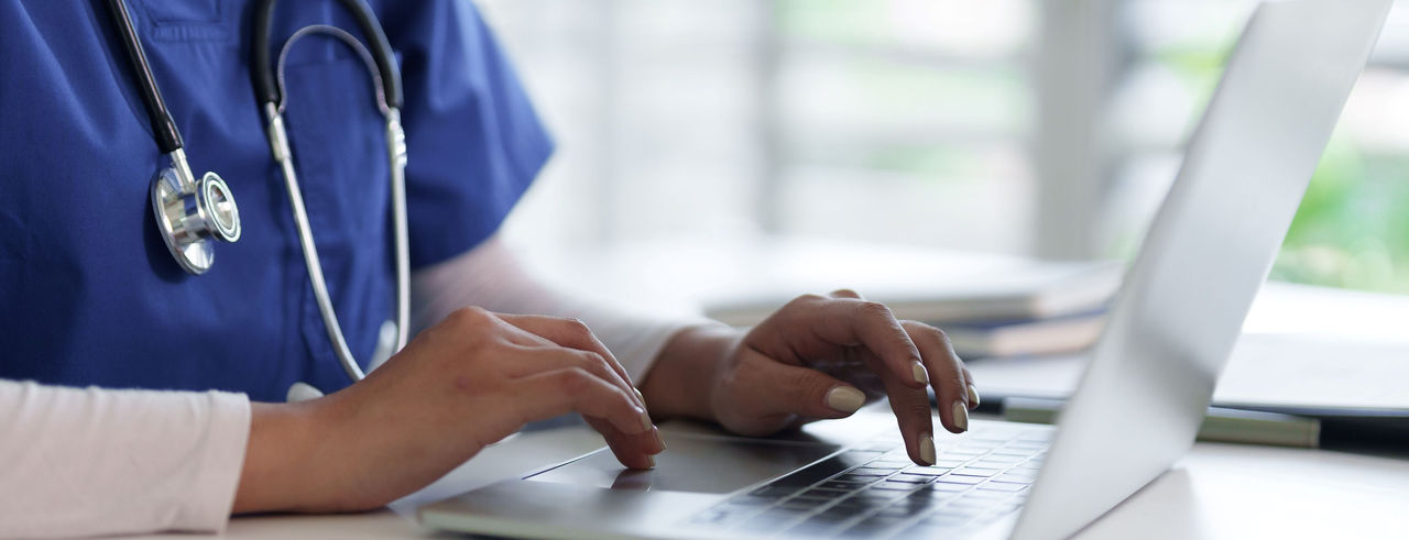 nurse tiping on laptop