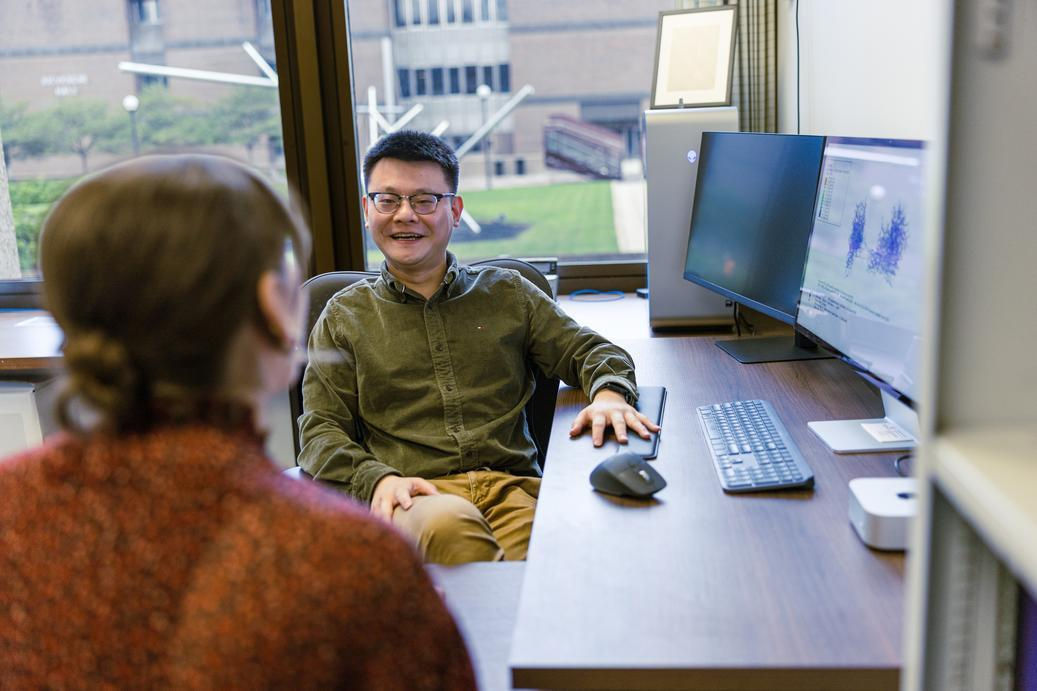 UC researcher Hanxun Jin talks to his doctoral student in his office in Cincinnati, Ohio.