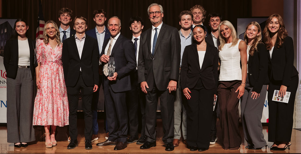 Real estate center students on stage with the executive director and award winner.