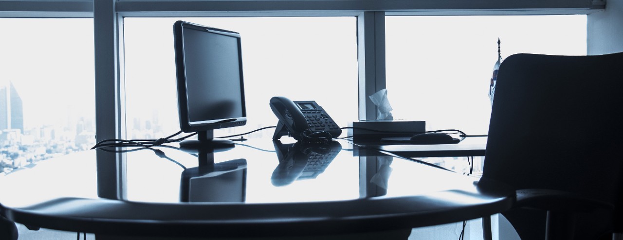 image of a computer and phone on a desk