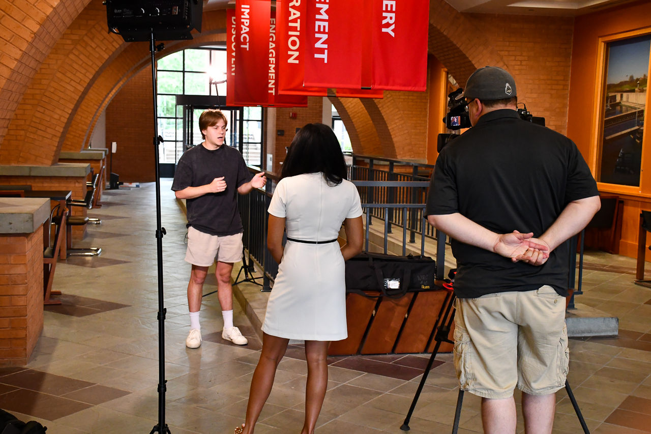 Eric Langhorne talks to Local 12 about his app in UC's Mantei Center.