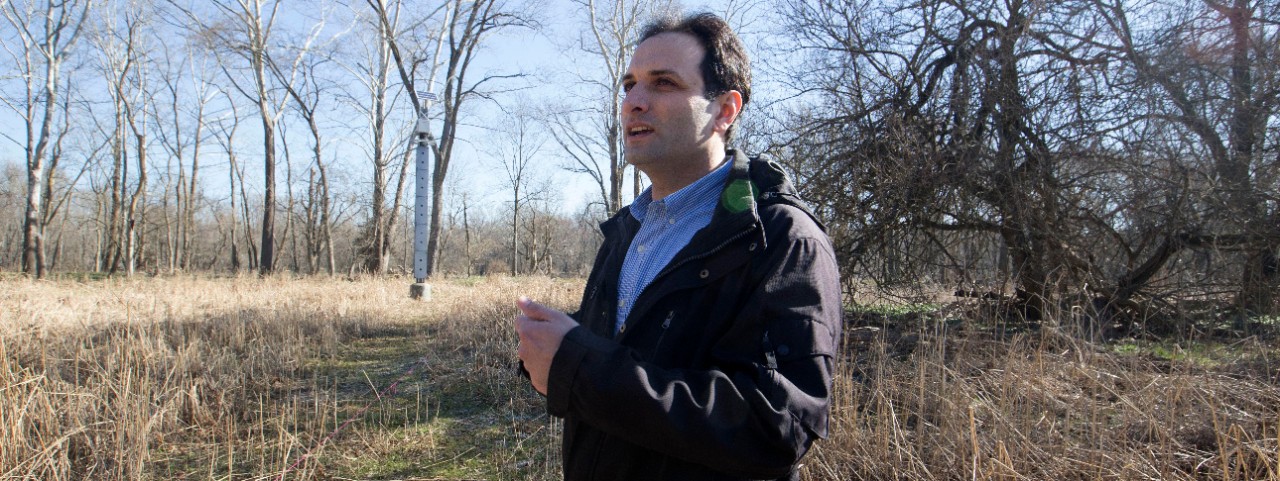 Reza Soltanian stands on the banks of the Great Miami River at UC's groundwater observatory.